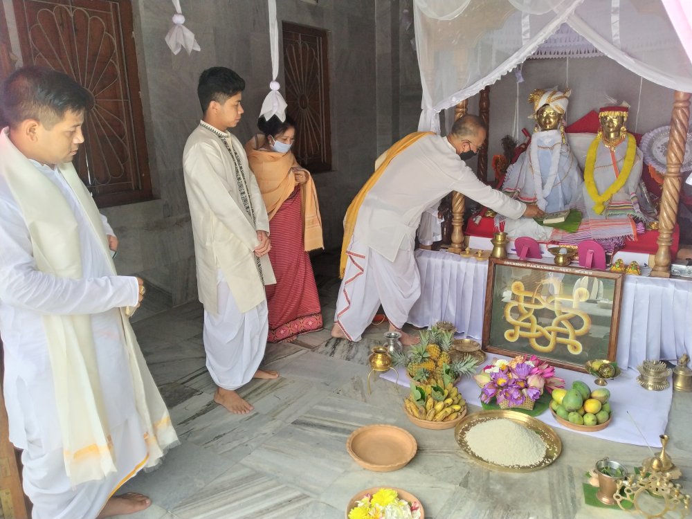   a family prayer offering of the book to Ibudhou Pakhangba at His shrine in Kangla Fort 