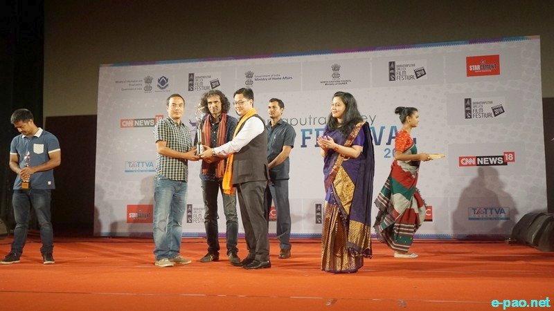 James Laphoi, on behalf of Romi Meitei recieving the first prize from Union Minister Kiren Rijiju : 4th Brahmaputra Valley Film Festival