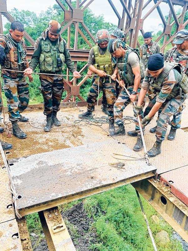 Joint team of Army, Assam Rifles helps in restoring damaged road
