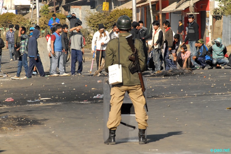 A policeman guarding during Bandh and protest in Imphal area on December 24 2012