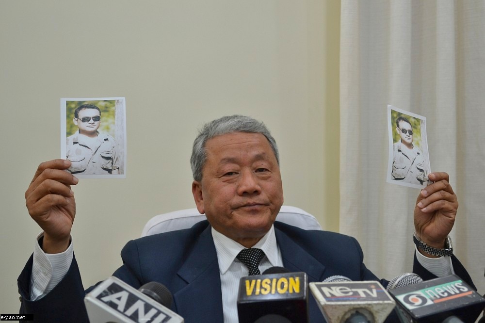 Deputy CM and Home Minister Gaikhangam holding a picture of wanted man - Livingstone - at a Press conference in Imphal on January 10 2013
